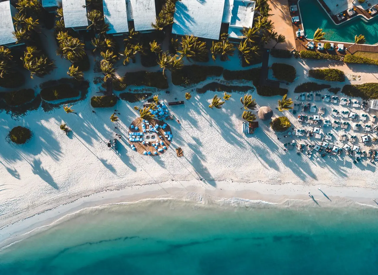An aerial view of a beach and coastal resort setting.