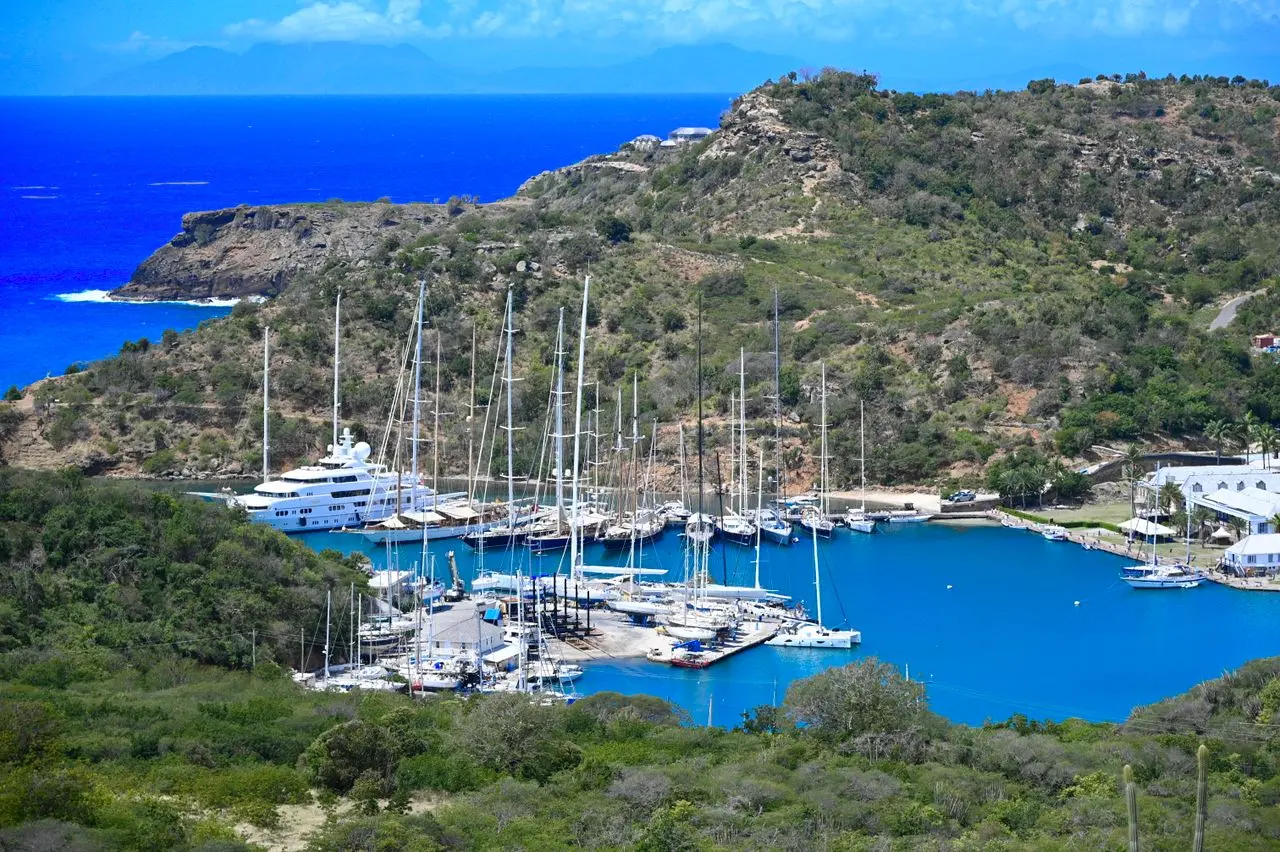 Yachts moored beside a sheltered marina.